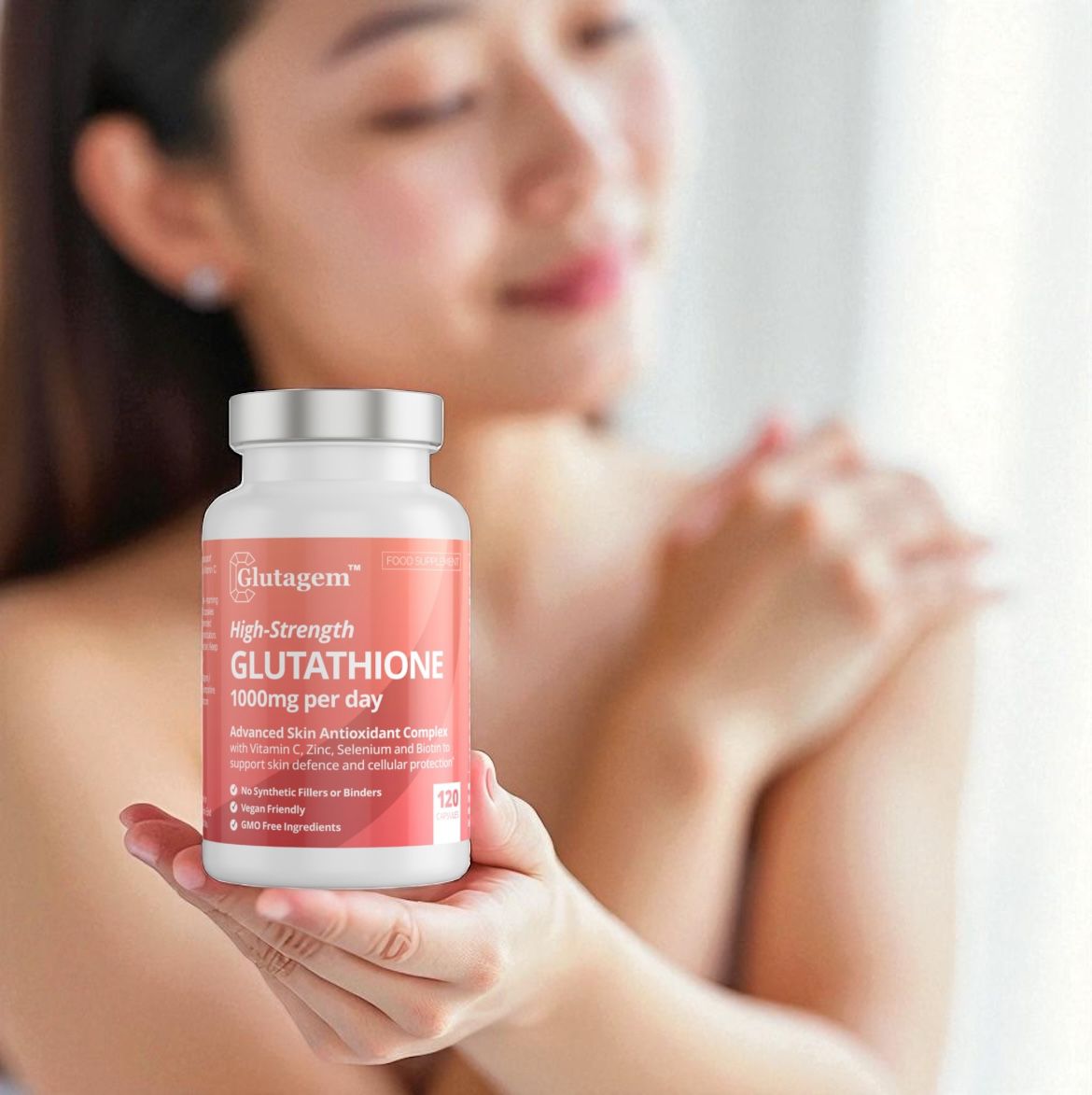 Woman with fair skin holding a Glutagem High-Strength Glutathione supplement bottle with a blurred background.